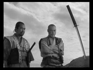 Two of seven samurai mourn a loss.